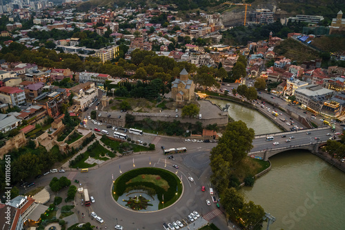 An aerial view of Tbilisis bustling cityscape at twilight encompassing historical architecture photo