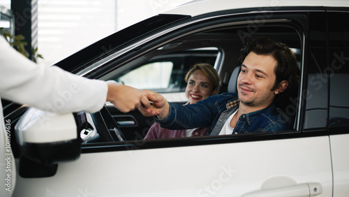 Captured the moment of handing over the keys after the deal was concluded. A happy family member is satisfied from large investments in their future.