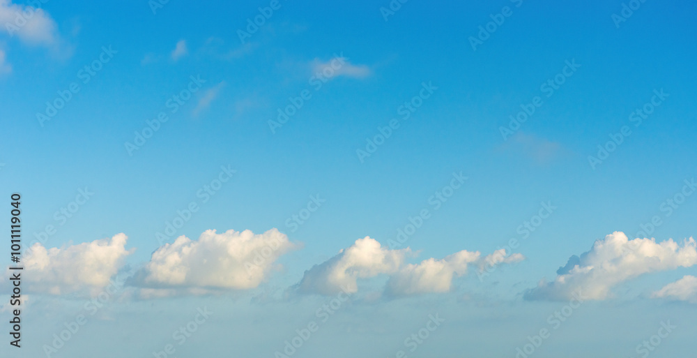 Serene Blue Sky with Fluffy White Clouds in Tranquil Atmosphere Serene Blue Sky with Fluffy White Clouds in Tranquil Atmosphere