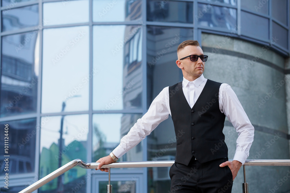 Stylish Businessman Posing Confidently in Urban Setting Stylish Businessman Posing Confidently in Urban Setting