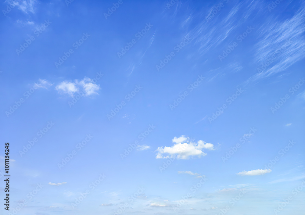 Obraz premium Serene Blue Sky with Gentle White Clouds for Tranquil Atmosphere