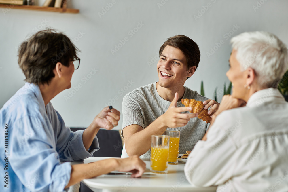 A loving LGBTQ family shares a delightful breakfast filled with laughter and conversation. A loving LGBTQ family shares a delightful breakfast filled with laughter and conversation.