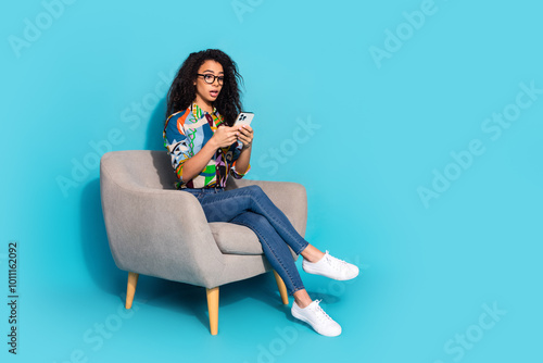 Photo of lovely worried nervous woman wear trendy clothes armchair read gadget isolated on blue color background