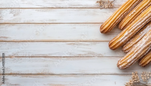 Churros on rustic white wooden background