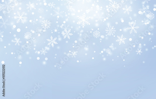 Falling snowflakes on a light blue background with a soft, blurred effect, creating a wintery and magical scene.