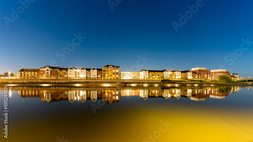 Barnstaple at night, modern houses reflected in the river Taw. Long exposure photo