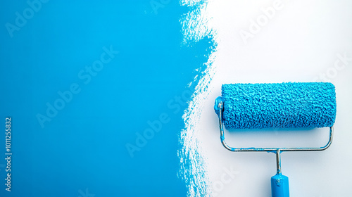 Fototapeta Naklejka Na Ścianę i Meble -  Paint roller applying fresh blue paint to white wall