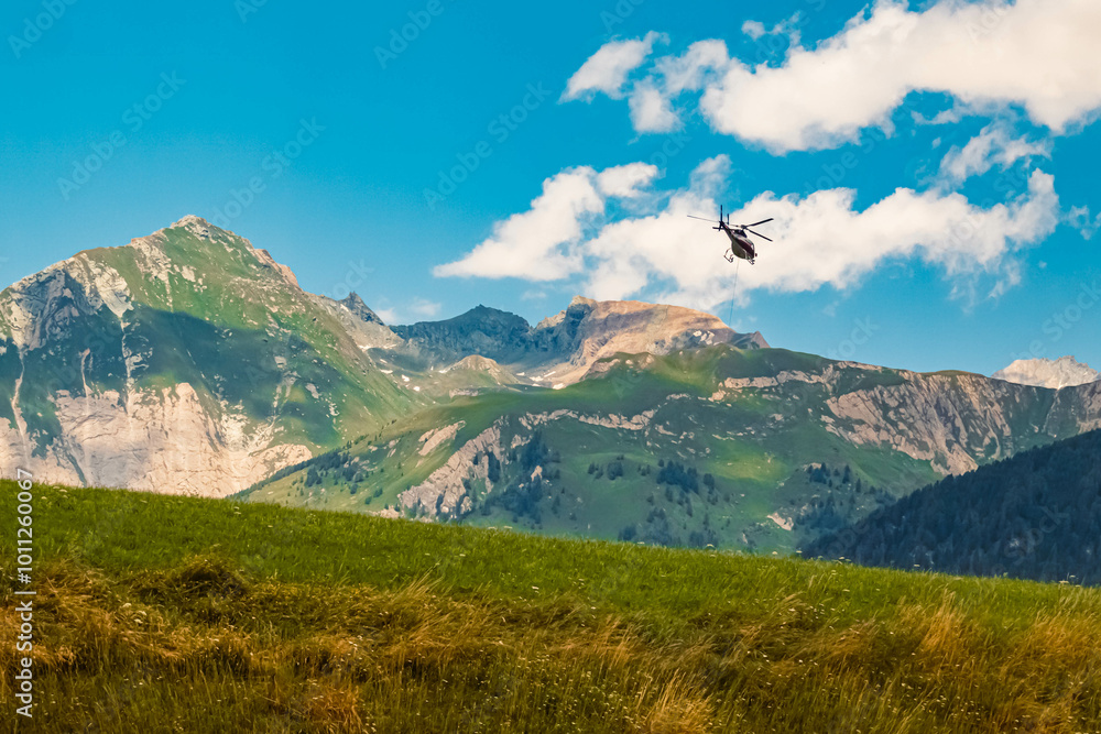 Fototapeta premium Alpine summer view with a helicopter in flight at Kalser Glocknerstrasse High Alpine Road, Kals am Großglockner, Lienz, Eastern Tyrol, Austria