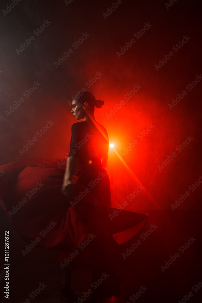 Silhouette of a woman in a red skirt dancing Latin in smoke in neon light. Dance concept. Bachata, Latina Silhouette of a woman in a red skirt dancing Latin in smoke in neon light. Dance concept. Bachata, Latina