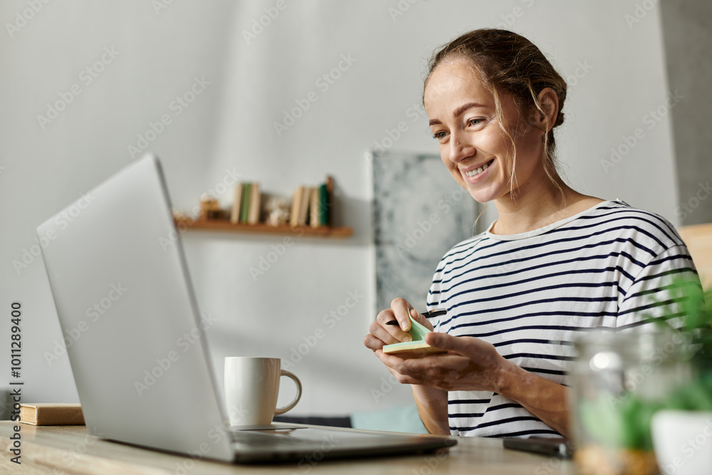 Young woman with vitiligo smiles while crafting at her home workspace. Young woman with vitiligo smiles while crafting at her home workspace.