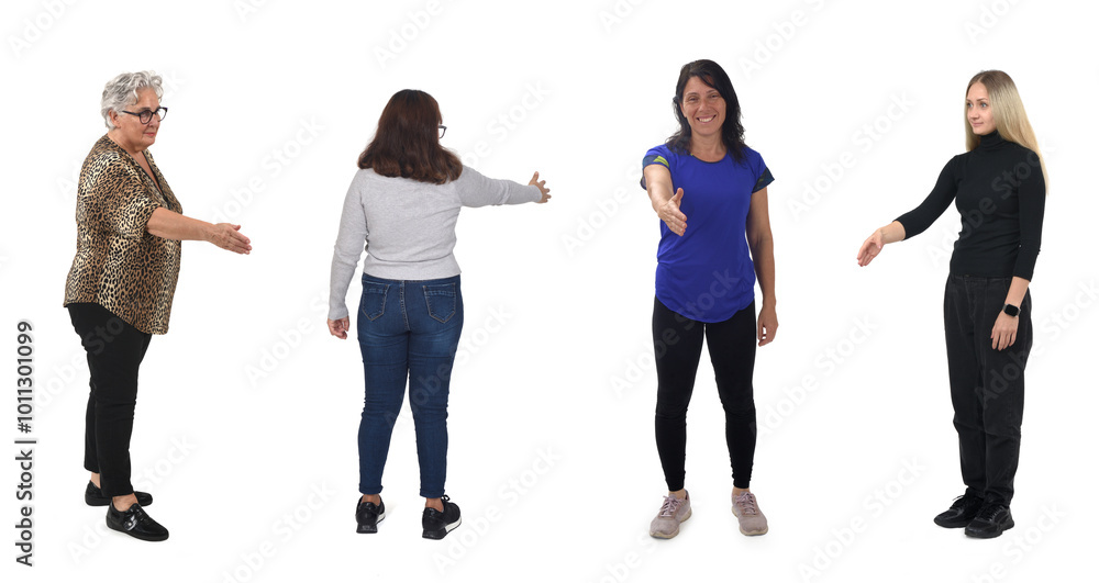 Fototapeta premium group of women shaking hands with imaginary person on white background