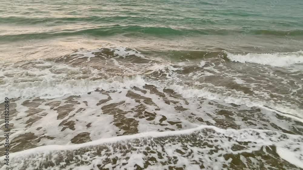 Waves Crashing on Sandy Beach. A close-up of waves crashing on a sandy beach. Waves Crashing on Sandy Beach. A close-up of waves crashing on a sandy beach.