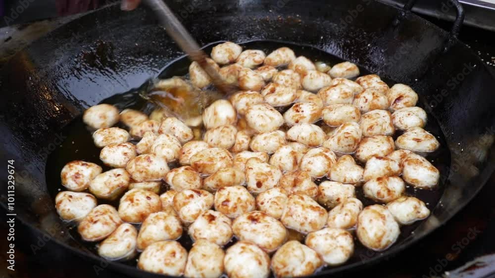 A food seller busy frying sesame sweet sticky rice balls skewers - Tang You Guo Zi - Sichuan snack
