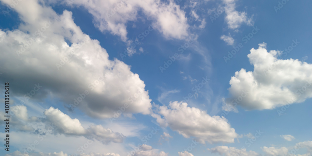 A beautiful sky with fluffy clouds against a vibrant blue background. Perfect for nature-themed designs or backgrounds. A beautiful sky with fluffy clouds against a vibrant blue background. Perfect for nature-themed designs or backgrounds.