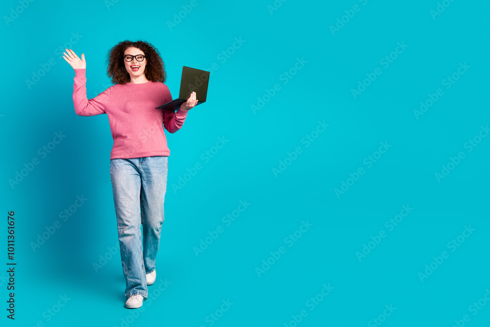 Full body portrait of nice young girl walk laptop arm wave hi isolated on turquoise color background Full body portrait of nice young girl walk laptop arm wave hi isolated on turquoise color background