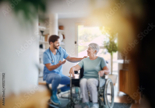 A healthcare worker talks to a smiling woman sitting in a wheelchair.