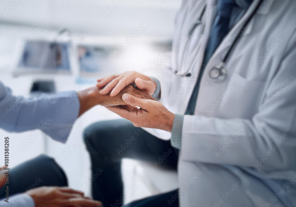 A doctor in a white coat holds the hand of a patient in a blue shirt. A doctor in a white coat holds the hand of a patient in a blue shirt.