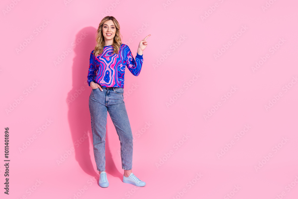 Photo of gorgeous adorable blonde curly hair lady wearing bright stylish sweatshirt point finger advertising isolated on pink color background Photo of gorgeous adorable blonde curly hair lady wearing bright stylish sweatshirt point finger advertising isolated on pink color background