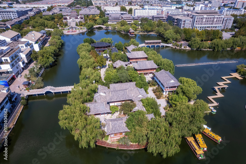 Serene Aerial View of Traditional Architecture Surrounded by Water and Lush Greenery photo