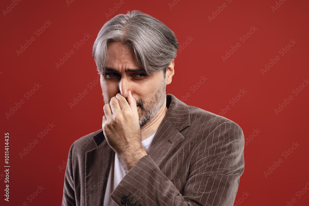 man holding his nose due to bad smell man holding his nose due to bad smell