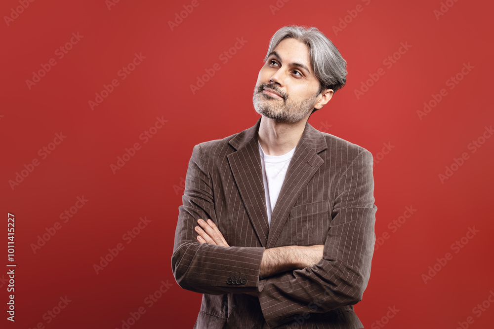 Fototapeta premium man with arms crossed looking up