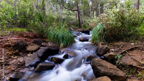 4k Motion Timelapse of water stream, waterfall, over rocks in forrest, Lesmurdie falls Perth, Western Australia photo