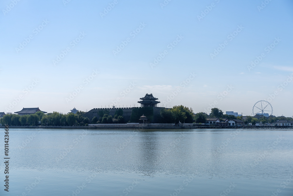 Obraz premium Tranquil Waterscape with Historic Architecture and Ferris Wheel