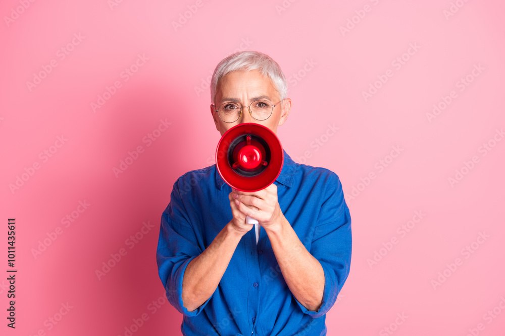 Fototapeta premium Photo of cheerful pretty lady dressed blue shirt shouting bullhorn empty space isolated pink color background