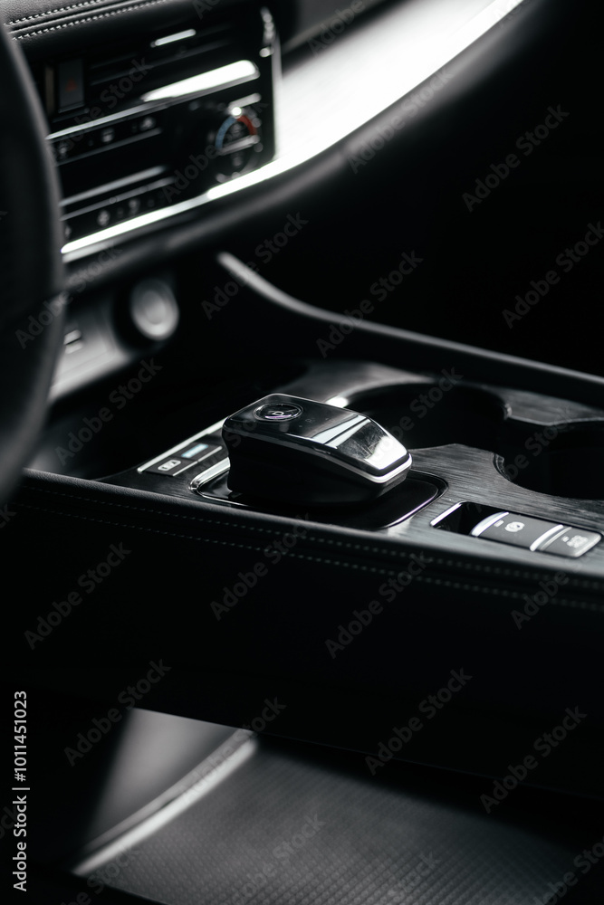 Modern car center console with electronic gear selector, stylish design, and control buttons. Ideal for automotive content, advertising, and blogs, highlighting comfort and technology Modern car center console with electronic gear selector, stylish design, and control buttons. Ideal for automotive content, advertising, and blogs, highlighting comfort and technology