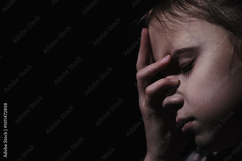 Pain in children. Very sad young girl. Loneliness, pain, child tragedy. Copy space for text or design. Pain in children. Very sad young girl. Loneliness, pain, child tragedy. Copy space for text or design.