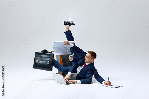 Cuadro en lienzo Businessman juggling multiple tasks, papers flying as he multitasks on floor