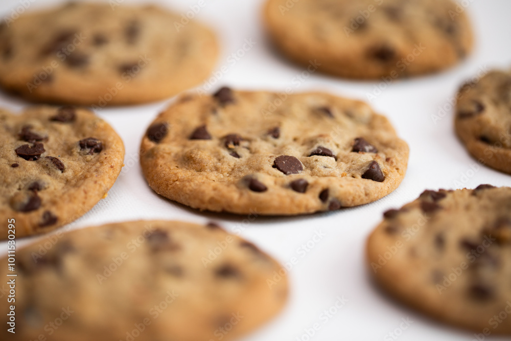 closeup of chocolate chip cookies on a white background closeup of chocolate chip cookies on a white background
