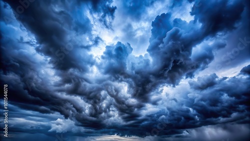 Moody dark blue sky with storm clouds background