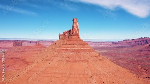 Drone aerial flying near orange rock tower remains formation of canyon in valley Colorado river Usa. Fantastic ancient landscape of desert nature and sandstone erosion. Sandstone butte rock formation