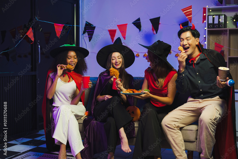 Obraz premium Dinner and group of people celebrating together at Halloween party.