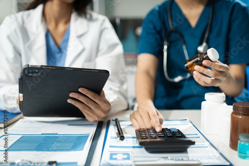 Doctor or accounting department writes a note and uses a calculator to calculate expenses - income. of hospital staff. photo