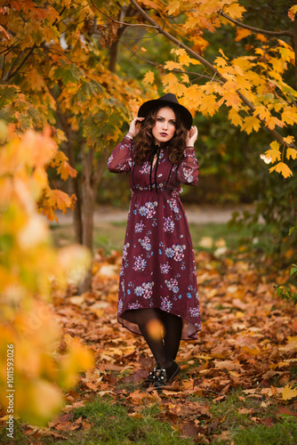 Hello autumn. Seen from behind middle aged woman in black hat