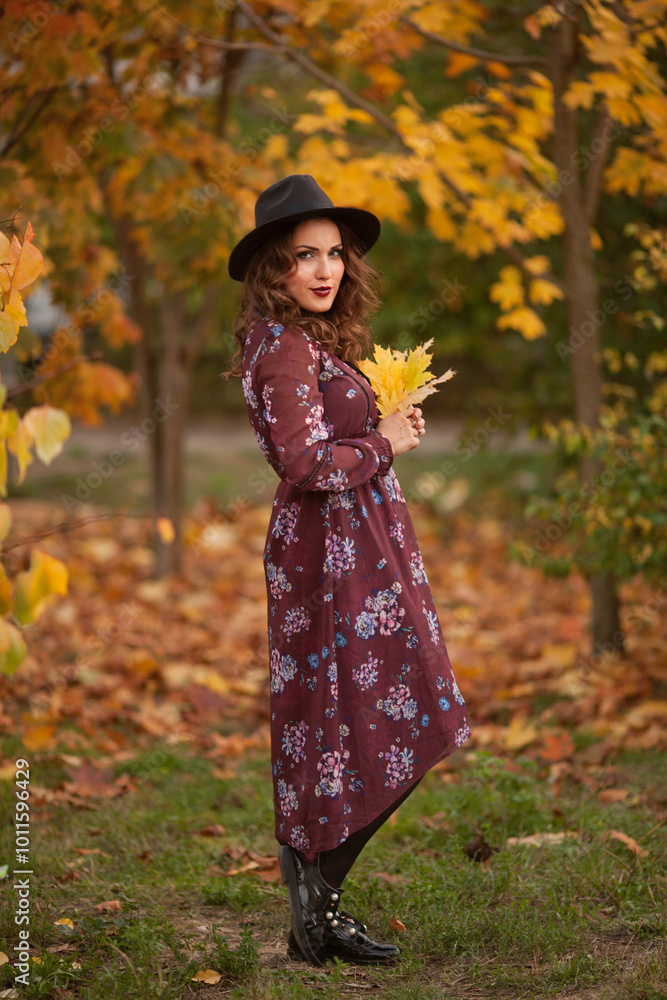 Hello autumn. Seen from behind middle aged woman in black hat Hello autumn. Seen from behind middle aged woman in black hat