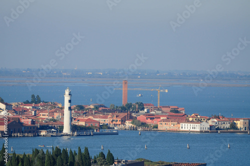 Venice, Veneto, Italy. October 23, 2010: A scenic view of Venice's canals with historic buildings and a prominent lighthouse.