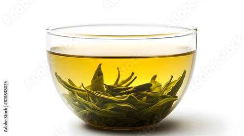 A clear glass bowl contains light yellow-green tea with loose green tea leaves submerged, emphasizing freshness and simplicity.