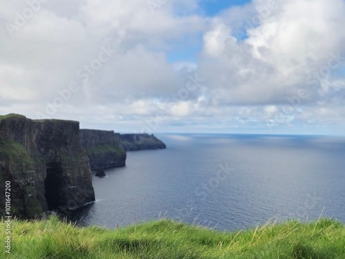 Scenic View Of Cliffs Of Moher: Emerald Coastline Overlooking Ocean Waves