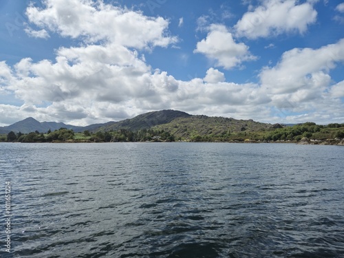 Serene River Waterscape With Little Waves And Cloud Reflections