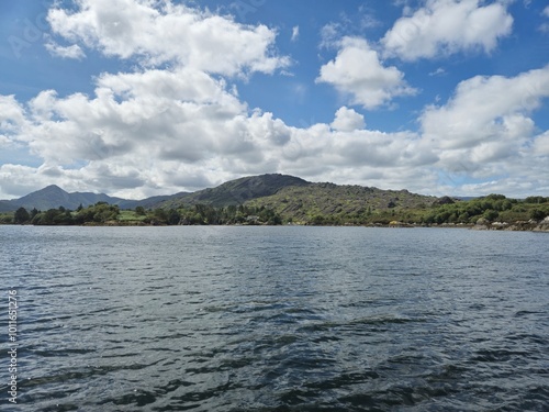 Serene Waterscape: Reflections Of Clouds And Little Waves