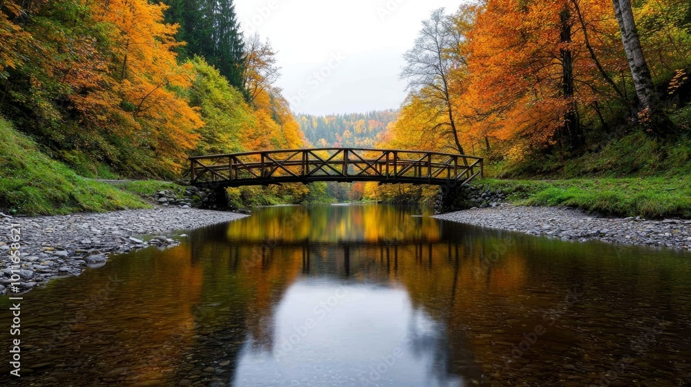 Picturesque autumn scene with a wooden bridge over a calm river surrounded by colorful trees. Picturesque autumn scene with a wooden bridge over a calm river surrounded by colorful trees.