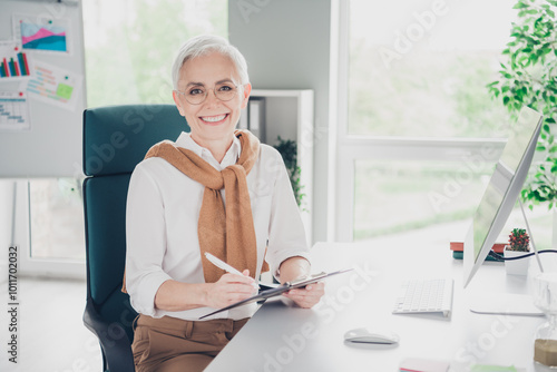 Photo of lovely senior lady professional write paperholder cheerful wear formalwear coworking successful businesswoman nice light office photo