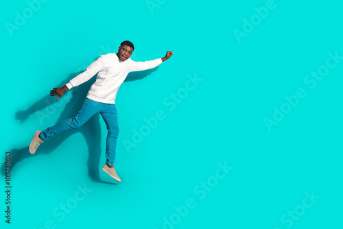 Full size photo of pretty young male flying superhero wear trendy white outfit isolated on aquamarine color background