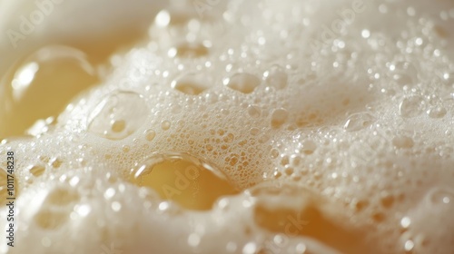 A detailed close-up shot of frothy beer foam and bubbles, showcasing the smooth texture and effervescent carbonation in a refreshing drink. photo