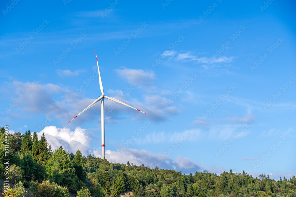 Majestic landscape of mountain top with industrial or wind turbine or wind power plant. White windmill for electric power production. Clean green wind energy. Ecological energy production. Majestic landscape of mountain top with industrial or wind turbine or wind power plant. White windmill for electric power production. Clean green wind energy. Ecological energy production.