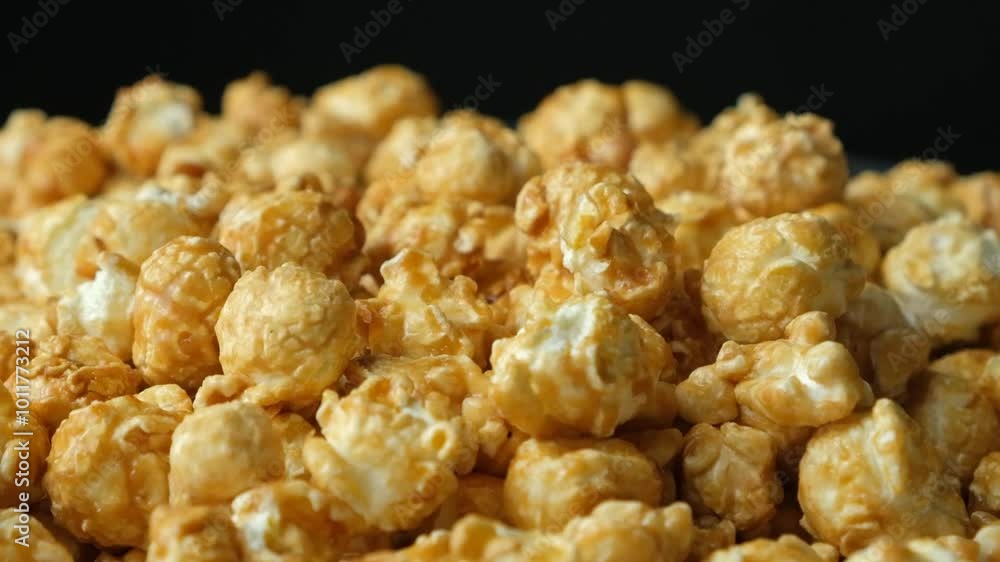 Slow rotation of caramelized popcorn, black background Slow rotation of caramelized popcorn, black background