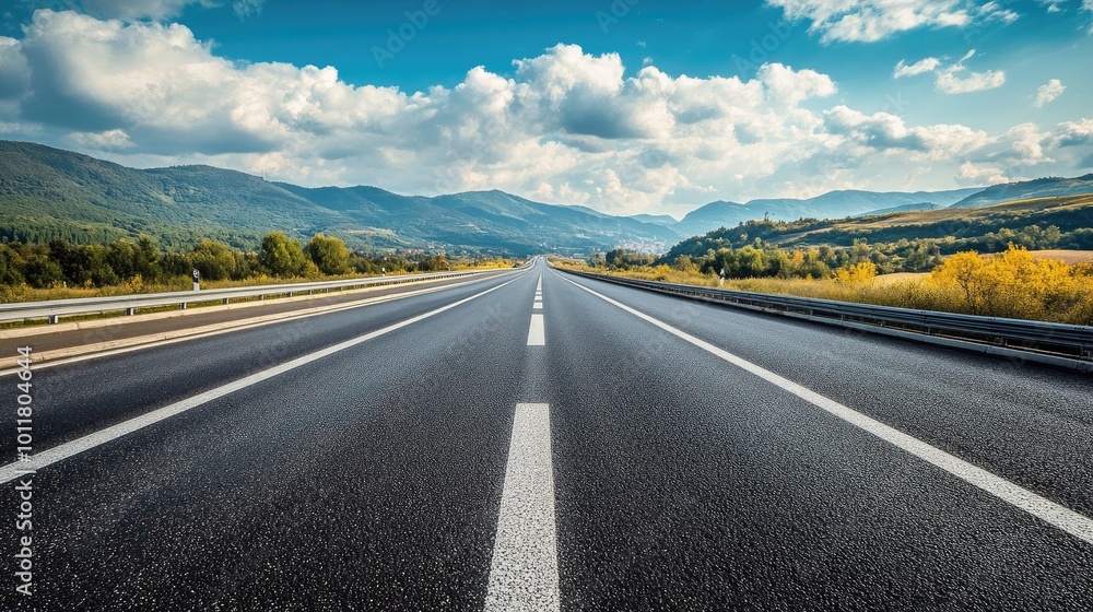 Fototapeta premium Scenic Highway Under Blue Sky and Mountains